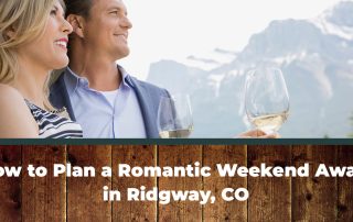 A couple enjoying a glass of wine during their romantic weekend away in Ridgway, Colorado.